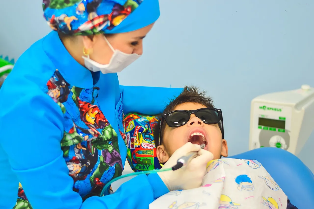 Smiling child receiving dental care in Orchard